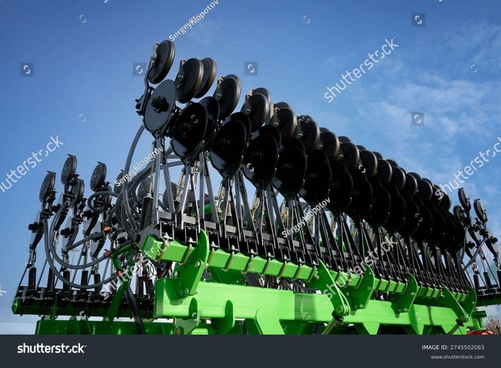 stock-photo-a-large-green-seed-drill-folded-against-a-cloudy-sky-new-agricultural-machinery-at-the-exhibition-2745502083.jpg