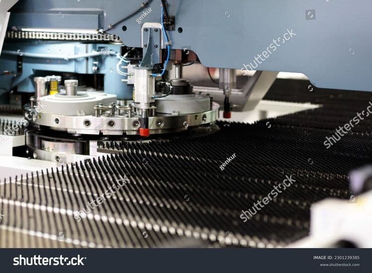 stock-photo-industrial-cnc-turret-punching-machine-close-up-selective-focus-2301239385.jpg