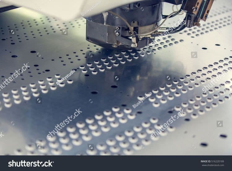 stock-photo-rotation-cnc-punching-nibbling-machine-in-action-metal-perforating-industrial-machine-516220189.jpg